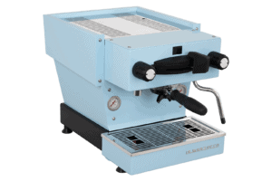 Badger and Dodo Coffee Roasters: The La Marzocco Linea Mini - Blue offers a portafilter handle, dual pressure gauges, and a right-side steam wand. Its elegant design includes a black base with a stainless steel drip tray, capturing modern sophistication.