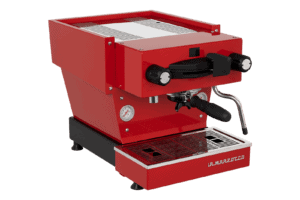 Badger and Dodo Coffee Roasters: The La Marzocco Linea Mini - Rossa espresso machine sports a sleek design with two knobs, a pressure gauge, and a steam wand. Its drip tray at the base prominently displays the La Marzocco brand on the front.