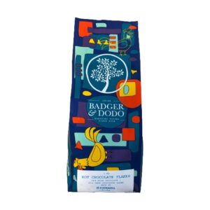A colorful 1 kg bag of Badger & Dodo roasted coffee, featuring an abstract blue, teal, yellow, orange, and red illustrated design with a stylized tree and bird.