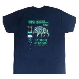 Badger and Dodo Coffee Roasters: Navy blue T-shirt with a vivid boar design, an AeroPress coffee maker illustration, and text: Irish AeroPress Championships 2024 and Badger & Dodo Roasters Coffee since 2008, subtly inspired by kettles.