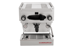 Badger and Dodo Coffee Roasters: The La Marzocco Linea Mini - Silver (Matte) features a stainless steel body with black handles, two precision gauges on the front, a central portafilter, and a right-side steam wand. The design is elegantly finished with a branded label at the bottom.