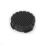 Black plastic AeroPress filter cap with a circular shape and multiple small holes on the top surface.