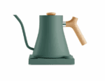 Modern electric gooseneck kettle in matte green with a natural wood handle and knob, placed on a matching green base.