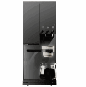A sleek, modern black coffee machine with a digital control panel and three knobs. The machine has a filter holder containing a white dripper and a glass carafe filled with coffee positioned underneath.