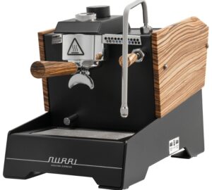 A modern, high-end espresso machine with a black metal body, chrome brew group, and wooden side panels and handles. It features a portafilter, a steam wand, and a minimalist front panel with the Nurri logo.